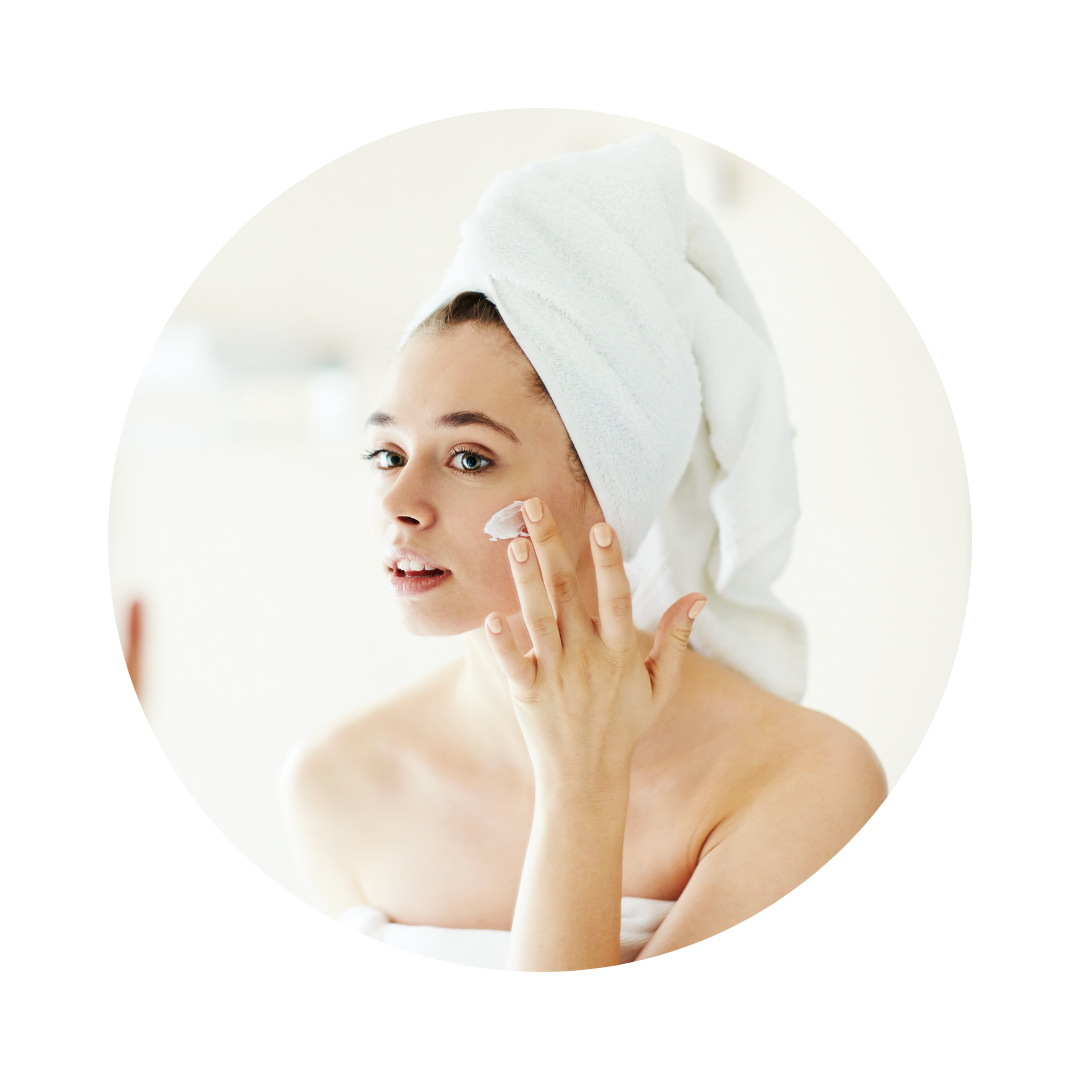 Female applying moisturizer to her face